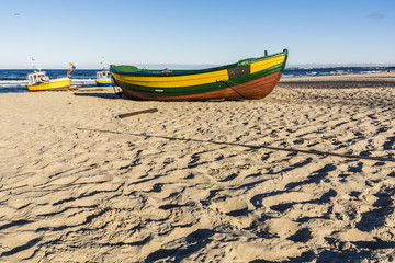 Wooden lifeboat on the beach.