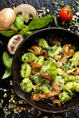 Potato Gnocchi with addition of herb pesto, cheese and mushrooms. Italian dish