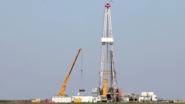 land oil drilling rig and cranes
