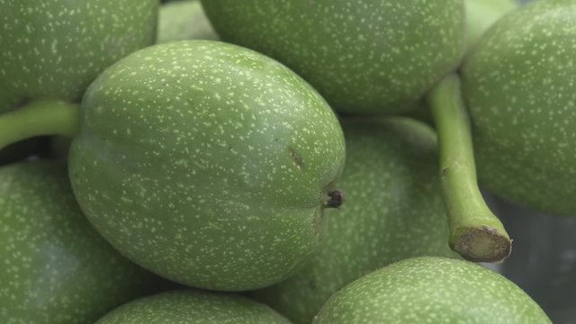 Green nuts closeup rotation in daylight