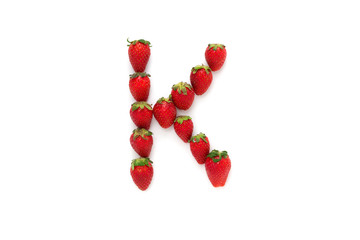 Alphabet "K" , letter from group of strawberries are arranged. Top view. Isolated on white background with shadow.