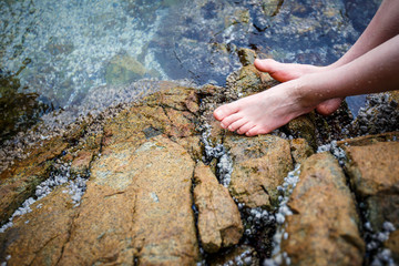 Boy's bare feet on the rock