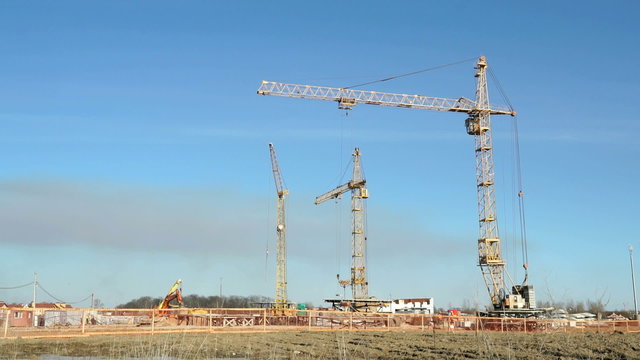 Construction cranes operate on the object