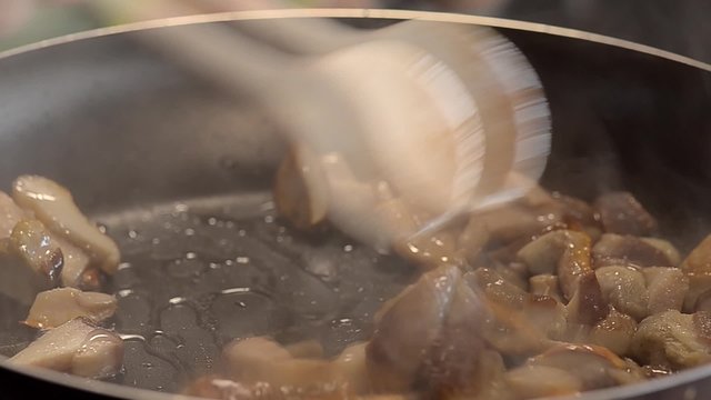 Sliced mushrooms fried ina hot pan