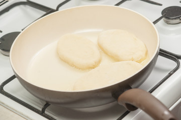 Patties with potato in the pan