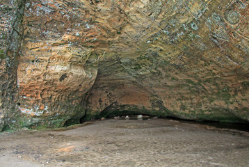 SIGULDA, LATVIA - MARCH 17, 2012: Old  inscriptions in the Gautmanis Cave located on the Gauja River in the National Park of Sigulda, Latvia
