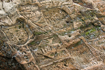 SIGULDA, LATVIA - MARCH 17, 2012: Old  inscriptions in the Gautmanis Cave located on the Gauja River in the National Park of Sigulda, Latvia