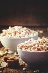 Puffed sweet rice on old wooden table, selective focus