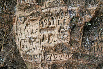 SIGULDA, LATVIA - MARCH 17, 2012: Old  inscriptions in the Gautmanis Cave located on the Gauja River in the National Park of Sigulda, Latvia