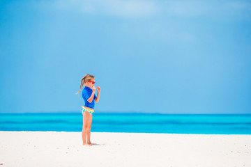 Fototapeta na wymiar Adorable little girl during beach vacation having fun