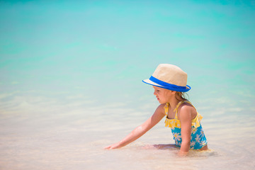 Fototapeta na wymiar Adorable little girl at beach during summer vacation