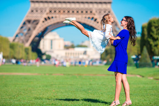 Adorable girl and happy mother in Paris background Eiffel Tower