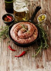 raw beef sausages on a cast-iron pan,  selective focus