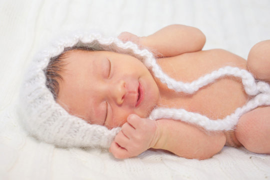 Sleeping smiling newborn baby