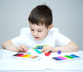 Boy playing with color play dough