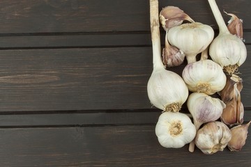 Fresh garlic on a wooden background. Traditional aromatic ingredients in food. Prevention against bad colds and flu.
