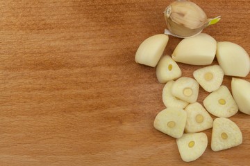 Fresh garlic on a wooden background. Traditional aromatic ingredients in food. Prevention against bad colds and flu.
