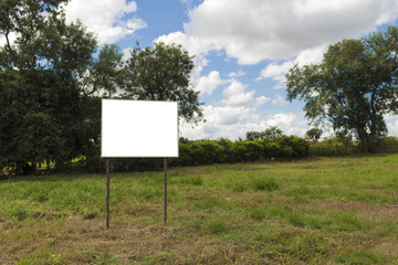 Empty board in front of beautiful cloudy sky in a rural location