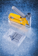 Straple gun metal staples on metallic background