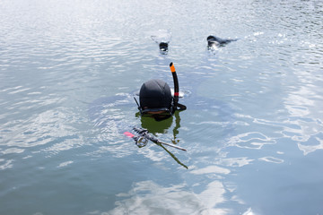 Man dressed as a hunter with an underwater scuba gun. 