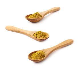 Wooden spoon of curry isolated