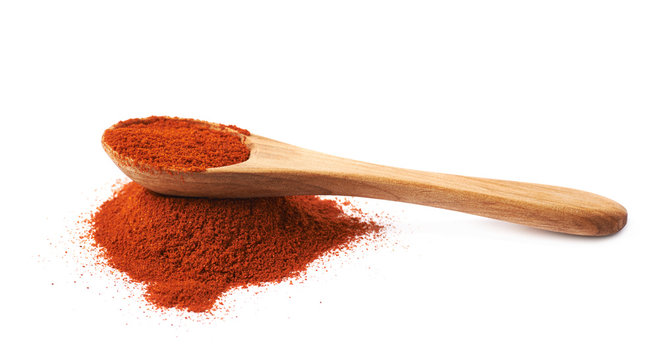 Wooden spoon over the pile of paprika