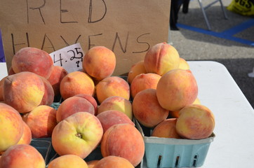 Fresh Peaches displayed for sale at an outdoor Farmers Market