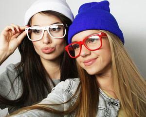 Two teenage girls friends in hipster outfit make selfie 