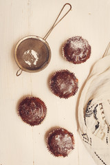 Top view on fresh baked chocolate muffins on the table