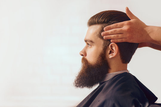 Bearded man sitting in the barbershop