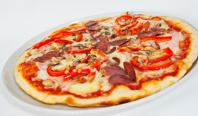 Appetizing pizza with mushrooms, salami, vegetables