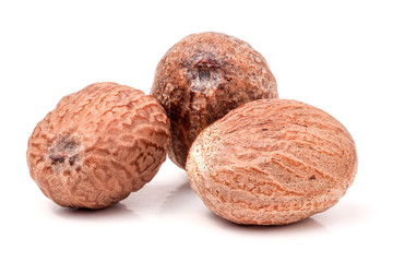 Three nutmeg whole  isolated on white background