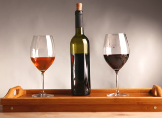 wine bottle and wine glass on a glass table