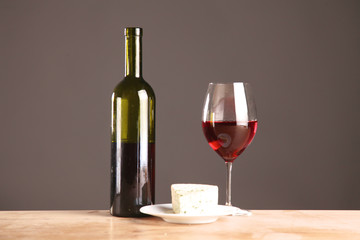 wine bottle and wine glass on a glass table