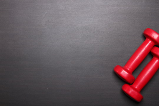Red dumbbell, fitness concept, top view