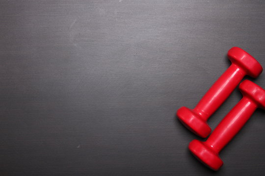 Red dumbbell, fitness concept, top view