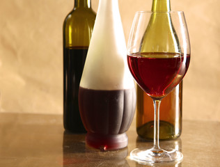 wine bottle and wine glass on a glass table