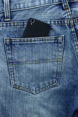 Little box with copy space to add text in the back pocket of blue jeans