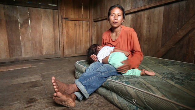 A heart wrenching scene of a mother and child living in dire poverty,singing in the beautiful Quechua language amidst the lush greenery of the Ecuadorian Amazonia.