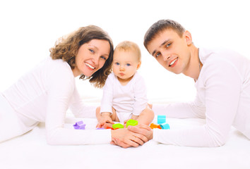 Obraz na płótnie Canvas Happy family together parents and baby playing with toys on floo