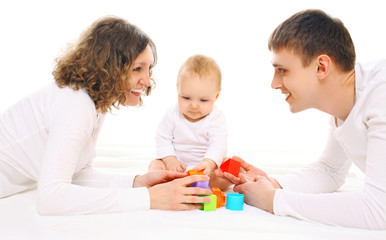 Obraz na płótnie Canvas Happy family together parents and baby playing with toys