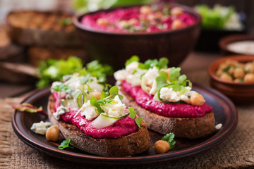 Vegan sandwiches with beetroot hummus, cucumber and blue cheese