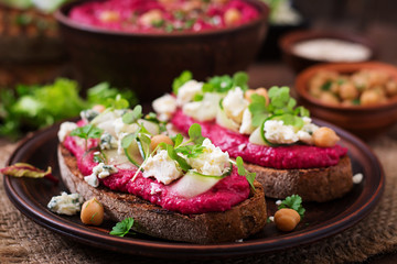 Vegan sandwiches with beetroot hummus, cucumber and blue cheese