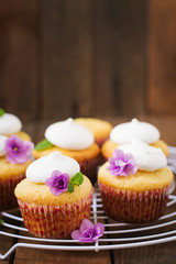 Cottage cheese cupcakes with meringue decorated flower and mint leaves