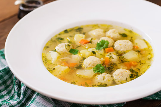 Dietary soup with chicken meatballs and stalks of celery