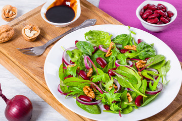Red beans salad with mix of lettuce leaves and walnuts