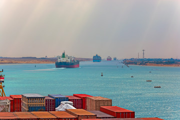 Industrial container ship passing through Suez Canal with ship's