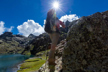 Man with backpack hiking in Caucasus mountains in Georgia