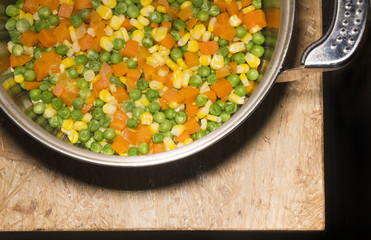 Vegetables in stock pot on wooden table, Food Conceptual Photo, top view