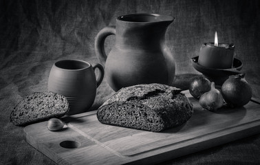 Still life with homemade bread and pottery, black and white phot